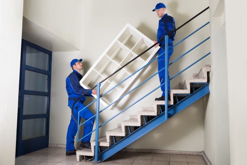 Man with van loading household furniture in Edgware