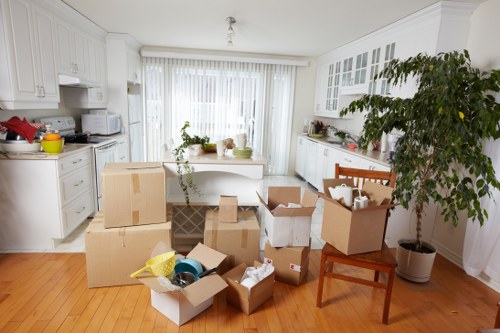Piano removals team planning access through stairs and narrow hallways