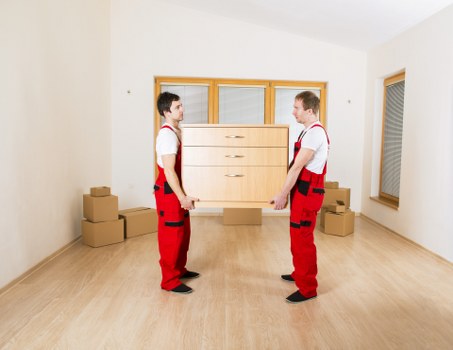 Moving crew transporting furniture through a flat building in Edgware